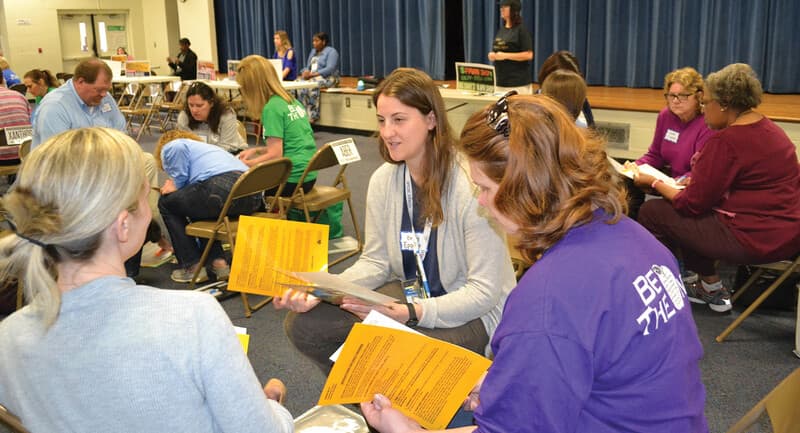 Photo of teachers meeting in a circle